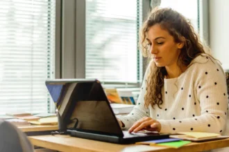 A young lady taking online classes with a laptop